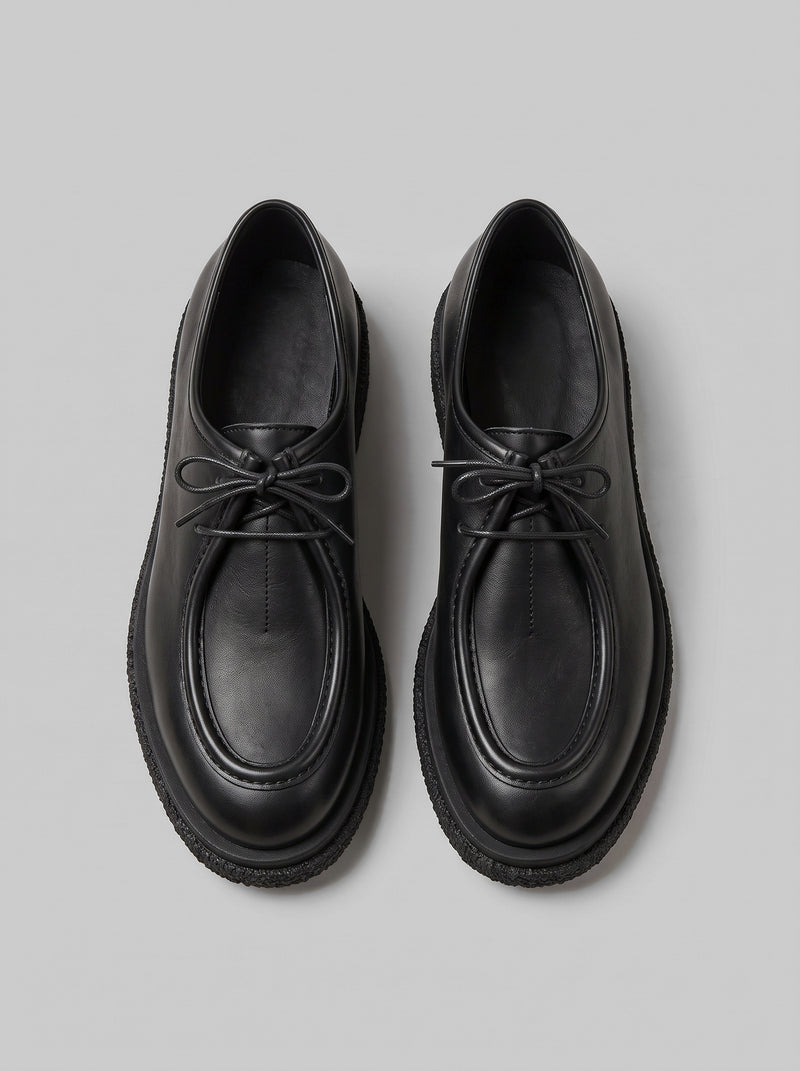 Lucca Black - נעל שרוכים מעור שחור עם תפר מוקסין בולט סביב החזית וסוליה עבה בעלת טקסטורה.